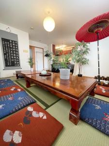 a living room with a table and a red umbrella at Japanese style villa - Vacation STAY 10392 in Tokyo