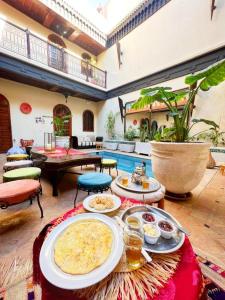 a living room with a table with food on it at RIAD KECHMARA in Marrakech