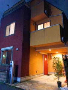 a red brick building with a balcony on it at Japanese style villa - Vacation STAY 10392 in Tokyo