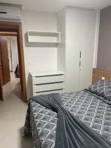 a bedroom with a bed and a white dresser at Itacimirim Beira Mar in Itacimirim +9 photos