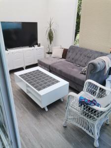 a living room with a couch and a coffee table at Apartment holidays and partys with a pool in Tuzla