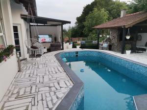 a swimming pool in a yard with a house at Apartment holidays and partys with a pool in Tuzla