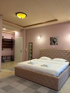a bedroom with a large bed in a room at Francesca Residence in Bucharest