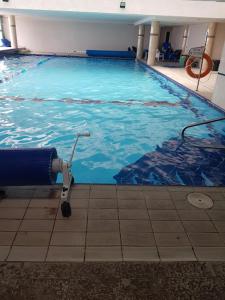 a large swimming pool with a blue water at Beachfront Hotel: Pool, Spa, wet/dry Sauna & Gym in Ashqelon