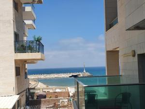 a view of the ocean from the balcony of a building at Beachfront Hotel: Pool, Spa, wet/dry Sauna & Gym in Ashqelon