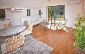 マロセーヌにあるAmazing Home In Malaucene With 1 Bedrooms, Wifi And Outdoor Swimming Poolのリビングルーム(ソファ、テーブル、椅子付)