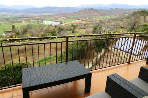 a balcony with a table and a view of a valley at Grace, apartamento con terraza y vistas in Talarn