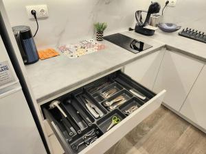 a kitchen with an open drawer in a counter at Nice Apartment near Flisvos in Athens