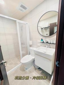 a bathroom with a toilet and a sink and a mirror at Meedori Coffee Home Stay in Hou-feng-kang