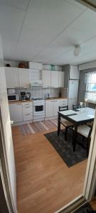 a kitchen with a table and a dining room table at RELAX, Heart of nature and lakes in Hyrynsalmi