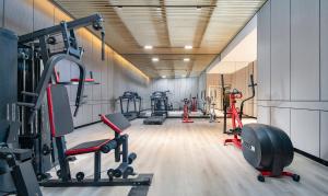 a gym with several treadmills and other exercise equipment at Liz Hotel in Guangzhou