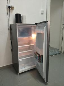 an open refrigerator with its door open in a kitchen at Batu Pahat Taman Banang Homestay in Batu Pahat
