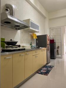 a kitchen with a stove and a stainless steel refrigerator at Yearned in Taitung City