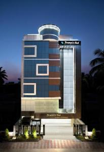 a building with a sign on the front of it at Ananyas Nest in Coimbatore