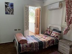 een kleine slaapkamer met een bed en een raam bij 5 bdr family villa with private pool and new AC, 5 min from beach in Alexandrië