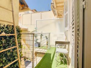 a small balcony with a chair and plants at 1 Bedroom flat with Balcony Cannes Center Croisette 6ppl in Cannes