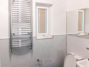 ein Bad mit einem WC, einem Waschbecken und einem Fenster in der Unterkunft Jayne Cottage in Tarbert