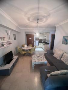 a living room with a couch and a table at Luxery suite GOLDCITY GOLD CITY Alanya in Alanya