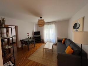 a living room with a couch and a table at Pension Boutique Doña Urraca in Burgos