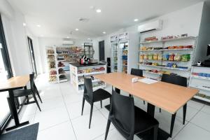 a kitchen with a table and chairs in a store at Rosey Hotel in Cabanatuan