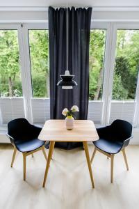 a dining room with a table and two chairs at Louis & Louise Apartments & Lofts Am Wall I Digital Check In in Bremen