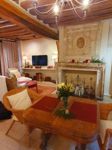 a living room with a table and a fireplace at La Venelle Saint Jean in Honfleur