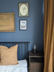 um quarto com uma parede azul com uma cama e uma mesa em Warsaw Studio Saska Kępa em Varsóvia