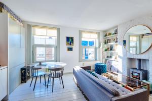 a living room with a couch and a table at Stylish Notting Hill Photographers Apartment in London