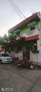 a motor scooter parked in front of a house at Villa Bonny Home Stay in Puducherry