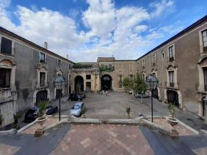 an empty courtyard in a building with cars parked at SINFONIA SUITES CATANIA in Catania