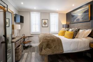 a bedroom with a large bed with yellow pillows at Marners Rock No 3 in Fowey