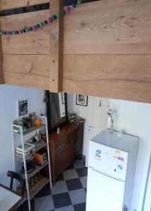 a kitchen with a refrigerator and a bunk bed at Le Stud' à Saint Pierre d'Oléron ! in Saint-Pierre-dʼOléron