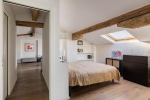 a bedroom with a bed and a skylight at Italy prestigious historical attic in Bologna in Bologna