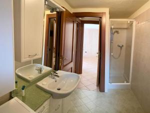 a bathroom with a sink and a shower at Appartamento alpino in La Salle