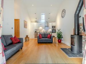 a living room with a couch and a fireplace at The Cow Shed in Farnham