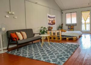 a living room with a couch and a table at A Little Bit Guesthouse in Melaka