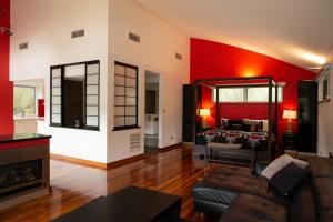 a living room with red walls and a couch at Silkwood Estate in Pemberton