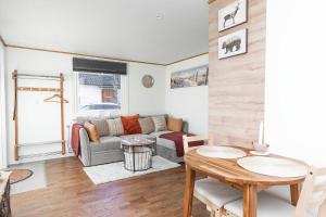 a living room with a couch and a table at Slottstuga in Borgholm