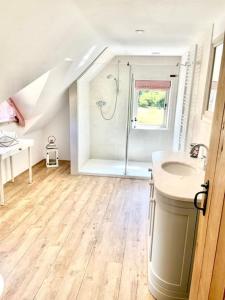 a bathroom with a shower and a sink at Meadow Cottage in Hampshire's Test Valley in Andover