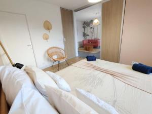 a bedroom with a large bed and a chair at L'Authentique ~ Lac 1 km ~ Parking gratuit in Annecy