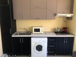 a kitchen with a washing machine and a sink at Дом Отель Бадамзар in Tashkent