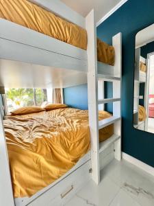 a bedroom with a bunk bed and a blue wall at Luxueux appartement - vue mer - piscine - free parking - Monaco in Cap d'Ail