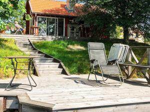 2 sedie e un tavolo su una terrazza in legno di Holiday home Bellö 