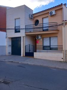 a building with balconies on the side of a street at Casa Rosangela in Almonacid de Toledo