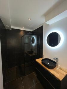 a bathroom with a black sink and a shower at Appart&Spa République in Dijon