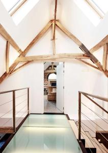 a glass floor in a room with wooden beams at Charly 132 in Ronquières