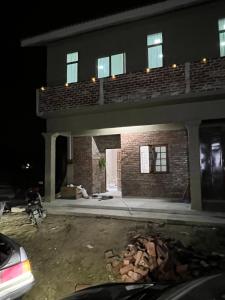 a house being remodeled at night with a garage at RUMAH CHANGGONG Studio in Kota Bharu