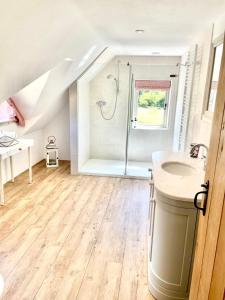a bathroom with a shower and a sink at Meadow Cottage in Hampshire's Test Valley in Andover