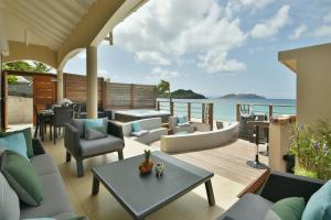 an outdoor living room with a view of the ocean at Villa Yvantino in Saint Barthelemy