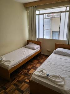 מיטה או מיטות בחדר ב-Vicz Palace Hotel